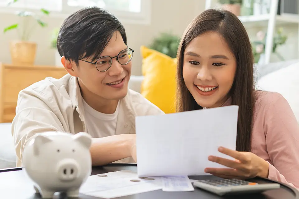 Father helping daughter prepare tax documents for the first time